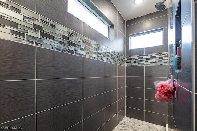 bathroom with tiled shower