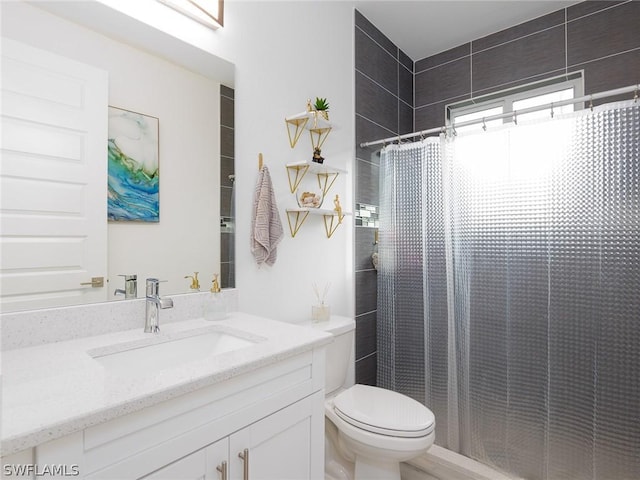 bathroom with a shower with curtain, vanity, and toilet