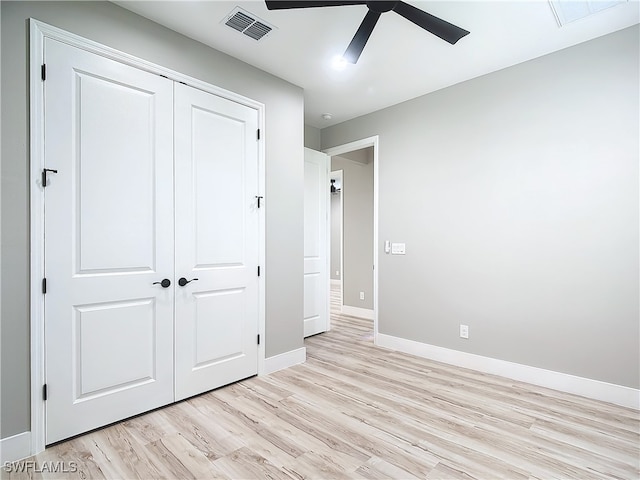 unfurnished bedroom featuring light hardwood / wood-style floors, ceiling fan, and a closet