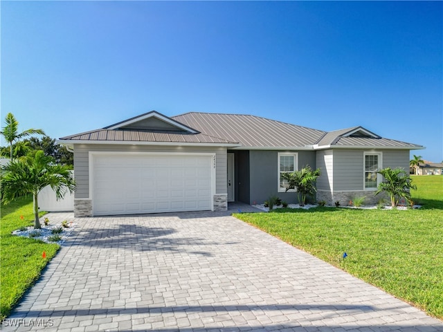 ranch-style home featuring a garage and a front lawn