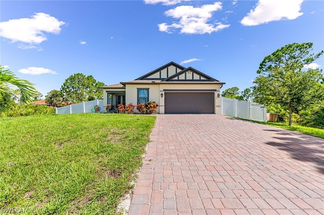 view of front of home with a front yard and a garage