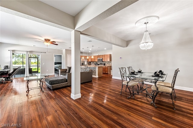 dining room featuring ceiling fan with notable chandelier and dark hardwood / wood-style flooring