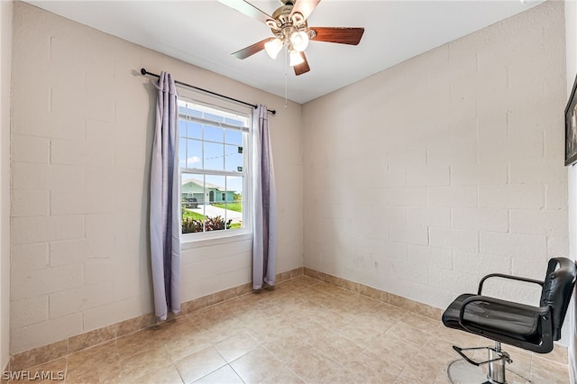 spare room with brick wall and ceiling fan