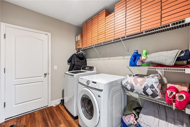 washroom featuring washer and dryer, dark wood-type flooring, and cabinets