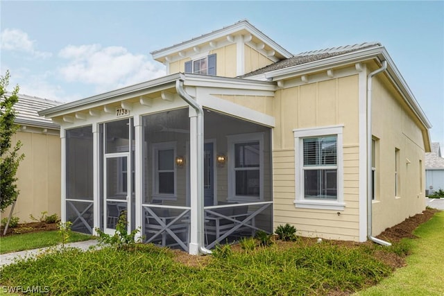 view of side of home with a sunroom