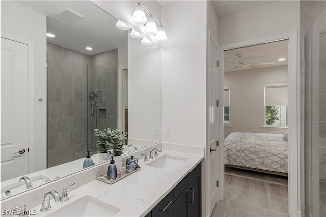 bathroom with tiled shower, vanity, tile patterned floors, and ceiling fan