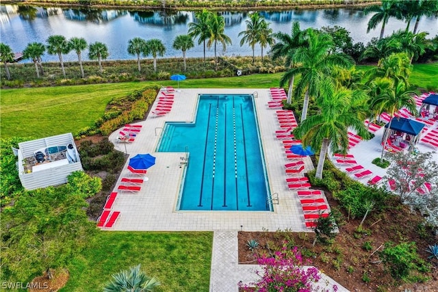 view of swimming pool featuring a water view and a yard