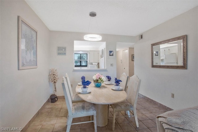 dining area featuring light tile patterned floors