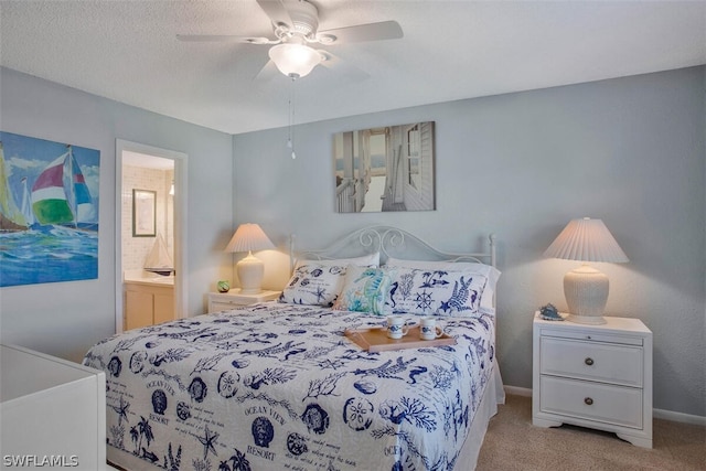 bedroom with light colored carpet, ceiling fan, and connected bathroom