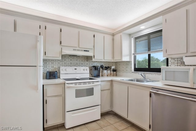 kitchen featuring white appliances, a textured ceiling, light tile patterned floors, white cabinetry, and sink