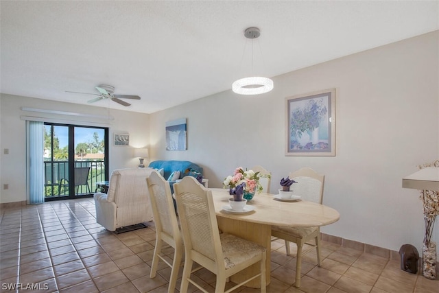 dining area with ceiling fan and light tile patterned floors