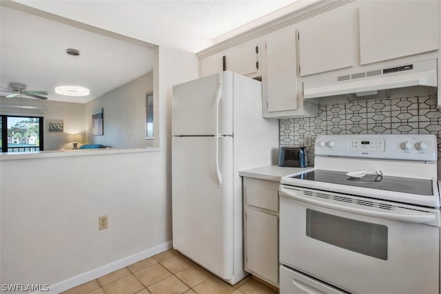 kitchen with white appliances, decorative light fixtures, light tile patterned floors, decorative backsplash, and white cabinetry