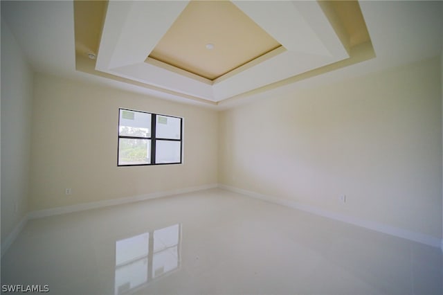 spare room featuring a tray ceiling