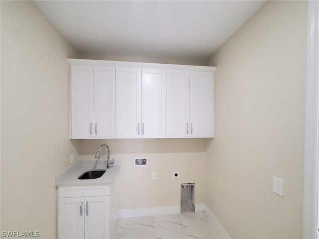 clothes washing area featuring light tile patterned flooring, sink, electric dryer hookup, cabinets, and hookup for a washing machine