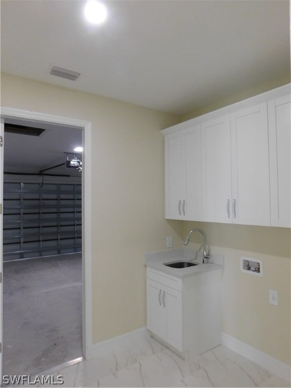 laundry area featuring sink, cabinets, and hookup for a washing machine