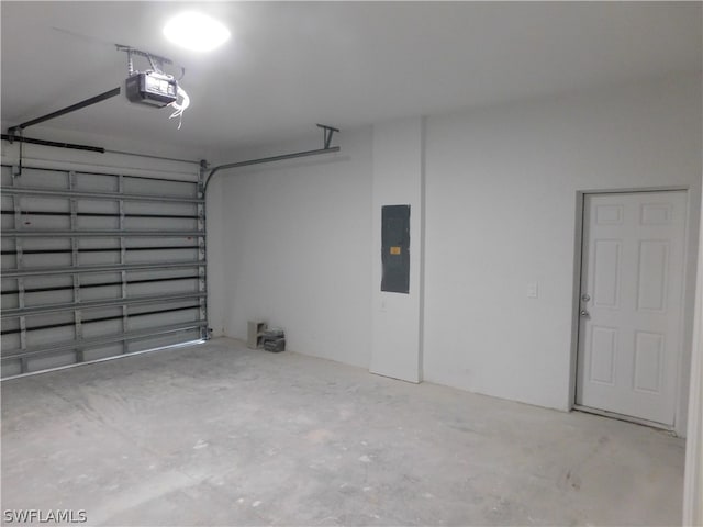 garage with electric panel and a garage door opener