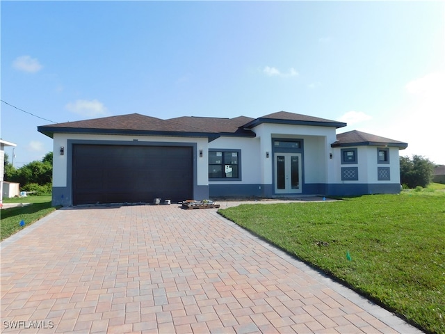 prairie-style home with a garage and a front yard