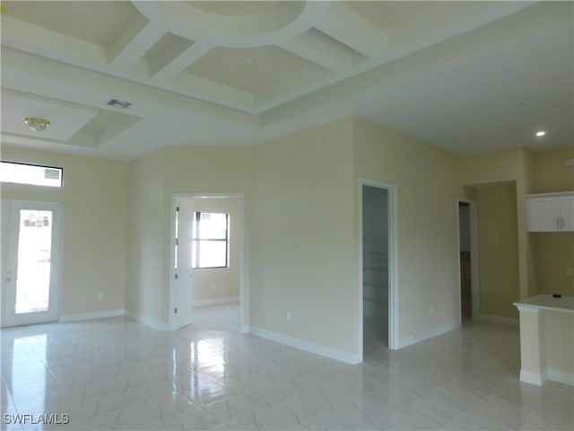 unfurnished room featuring coffered ceiling and light tile patterned floors