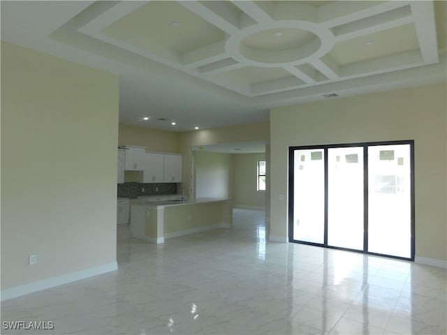 unfurnished room with beam ceiling, coffered ceiling, and light tile patterned floors