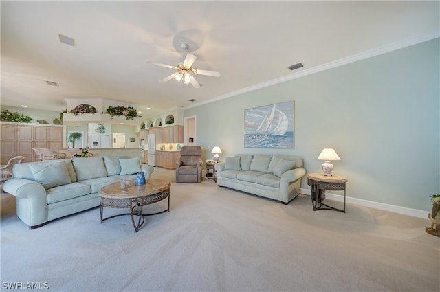 living room featuring light carpet, ceiling fan, and ornamental molding