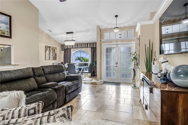 interior space with a chandelier, french doors, and crown molding