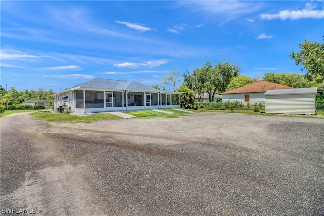 view of front of house featuring a sunroom