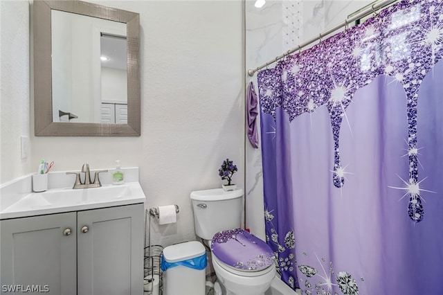 bathroom with a shower with curtain, vanity, and toilet