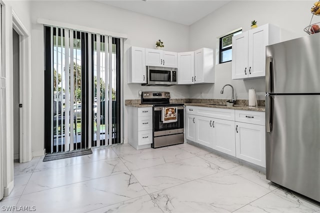 kitchen with white cabinetry, sink, and appliances with stainless steel finishes