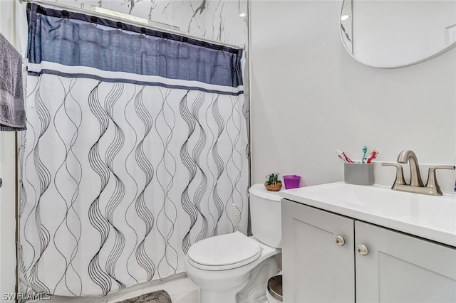 bathroom featuring vanity and toilet