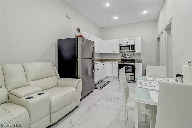 kitchen with white cabinets and appliances with stainless steel finishes