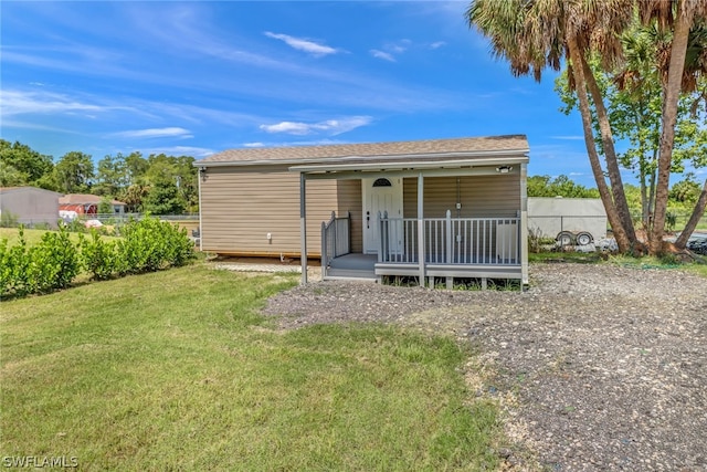 back of house with a lawn