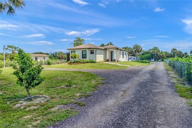 single story home featuring a front yard