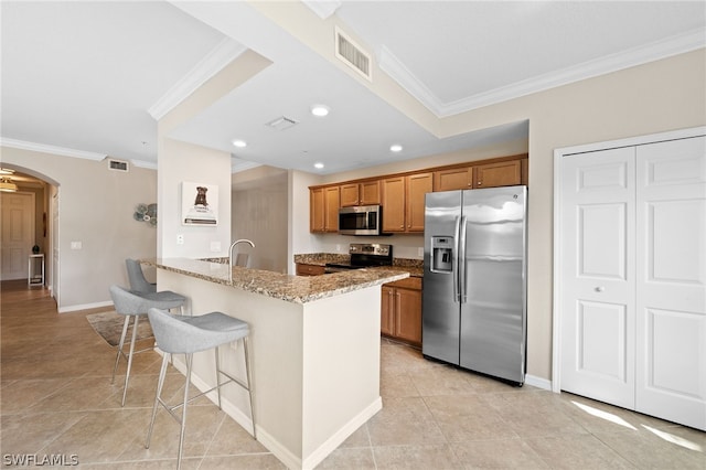 kitchen with stainless steel appliances, light stone counters, kitchen peninsula, light tile patterned floors, and crown molding