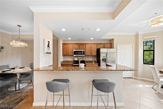 kitchen with light tile patterned flooring, a breakfast bar area, kitchen peninsula, and stainless steel appliances