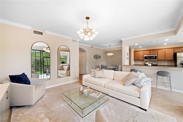 living room featuring a chandelier, light tile patterned floors, and crown molding