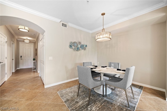 dining room featuring tile patterned floors and crown molding