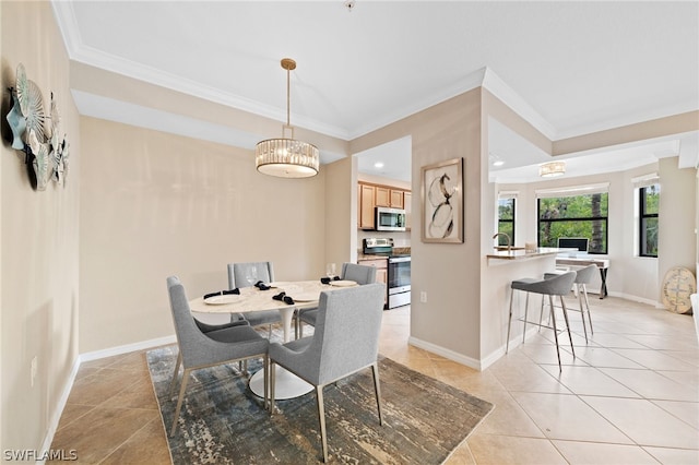 dining room featuring sink, crown molding, a notable chandelier, and light tile patterned floors