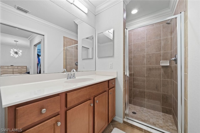 bathroom with vanity, a shower with door, tile patterned flooring, and crown molding