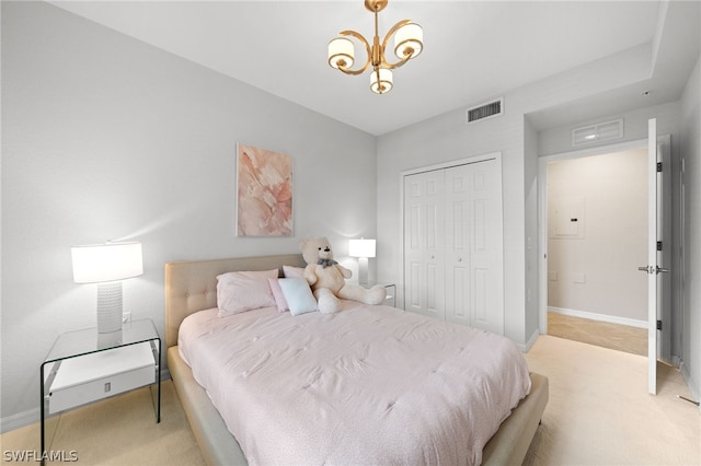 carpeted bedroom with a notable chandelier and a closet