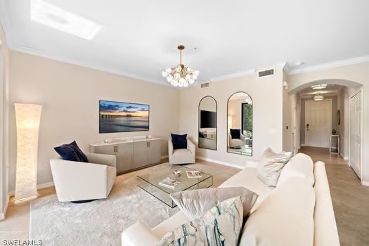 living room featuring an inviting chandelier and ornamental molding