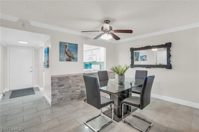 dining area featuring ceiling fan, crown molding, light tile patterned floors, and a textured ceiling