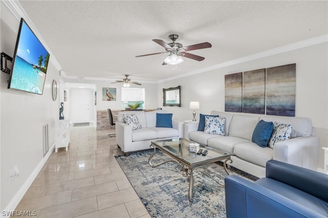 living area featuring light tile patterned floors, a textured ceiling, crown molding, and ceiling fan