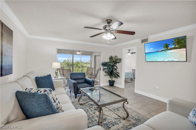 living area featuring light tile patterned floors, visible vents, baseboards, ornamental molding, and a textured ceiling