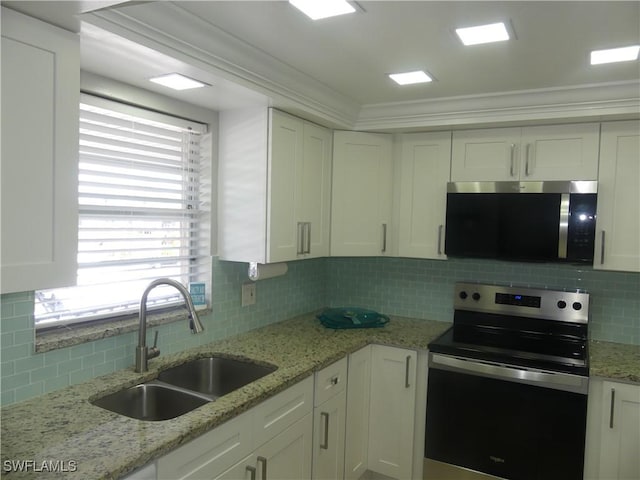 kitchen with a sink, appliances with stainless steel finishes, and white cabinets