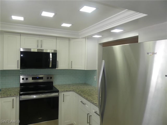 kitchen with stainless steel appliances, backsplash, white cabinets, and crown molding