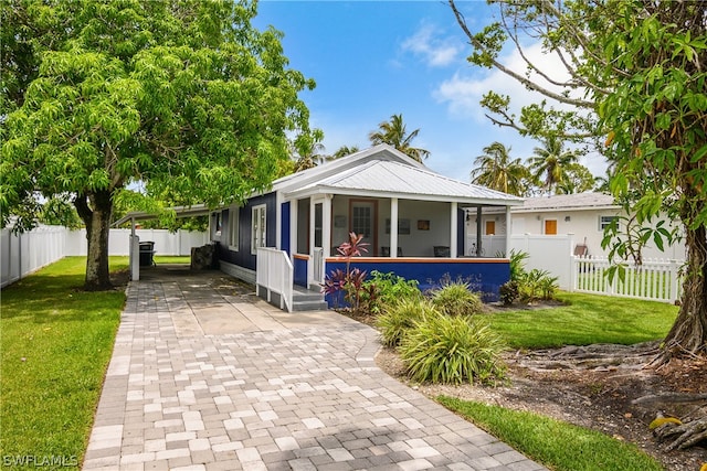 view of front of property with a porch and a front lawn