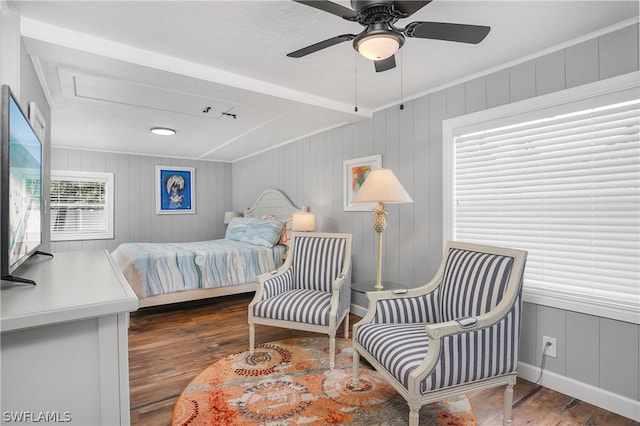 bedroom with ceiling fan, crown molding, and dark wood-type flooring