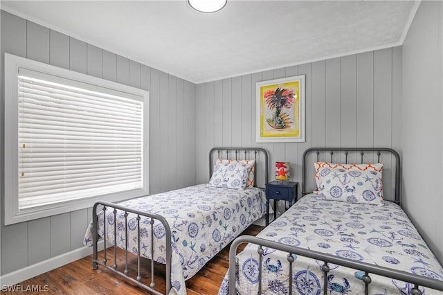 bedroom featuring crown molding and dark hardwood / wood-style floors