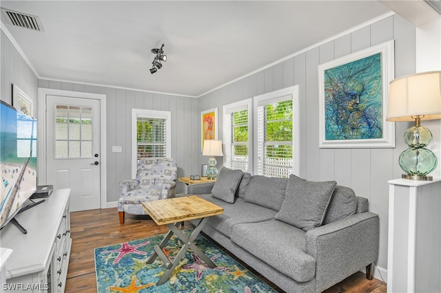 living room featuring ornamental molding and dark wood-type flooring