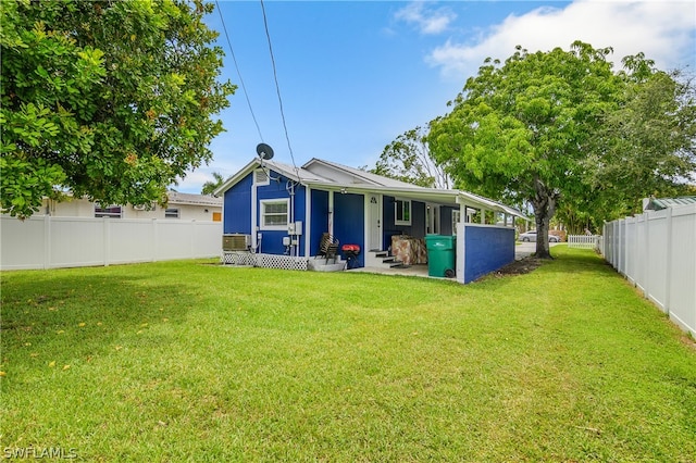 rear view of property with a yard